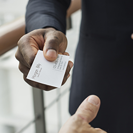 Person handing business card to another